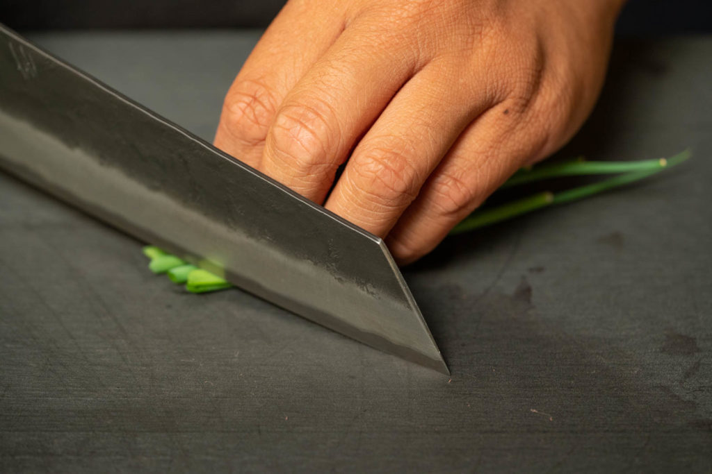 Diagonally slice green onions