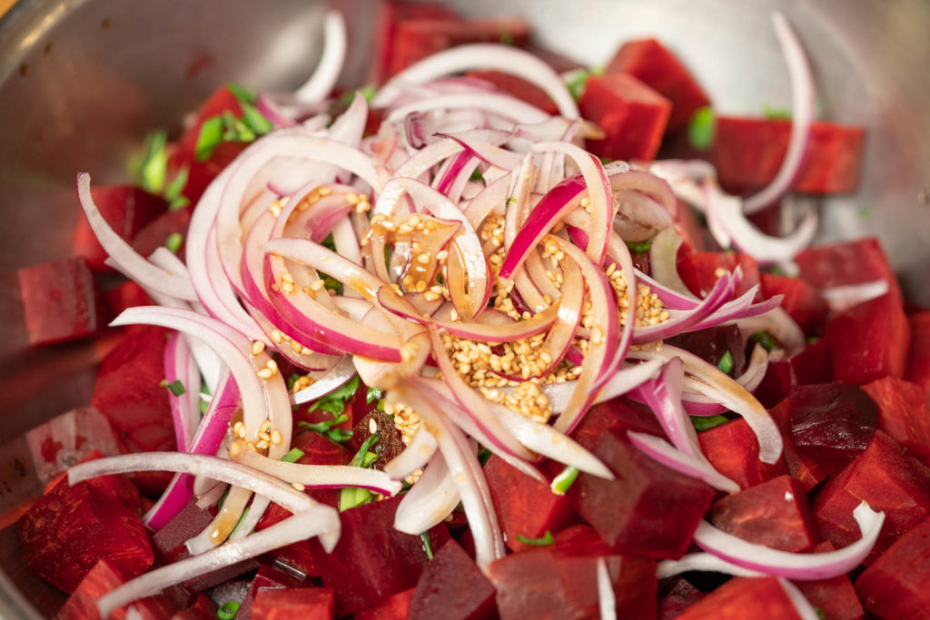 Pour sauce over beets and onions and mix well