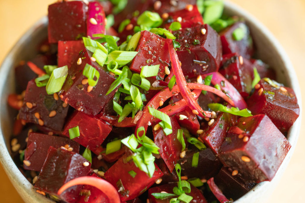 Serve beet poke with extra green onion and sesame seed garnish
