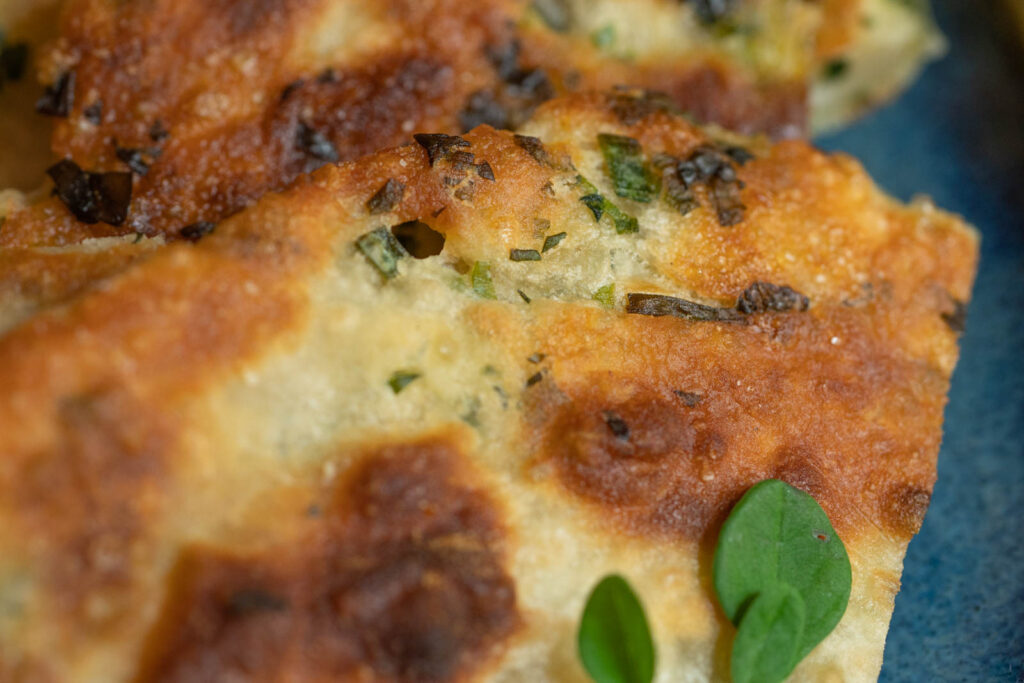 Green onion and moringa flecks in the pancake