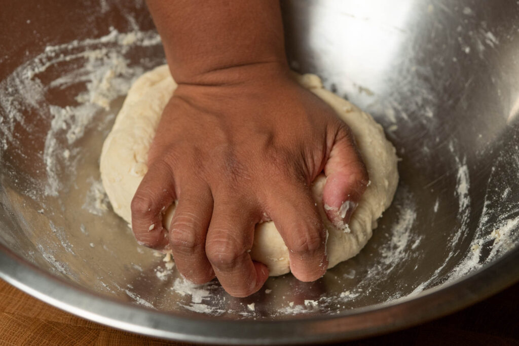 Stir until dough comes together, then remove bowl