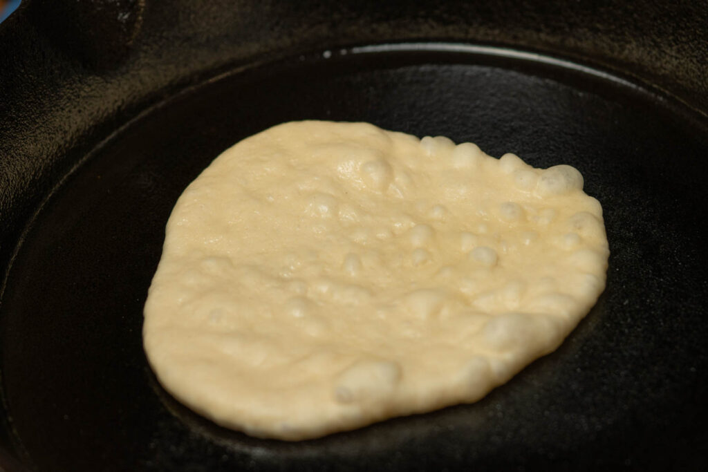 Use a cast iron pan on med-high heat until the first side begins to bubble, then flip