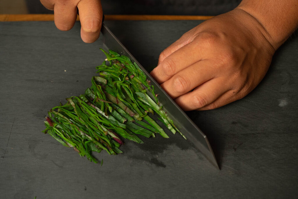 Thinly slice malabar spinach