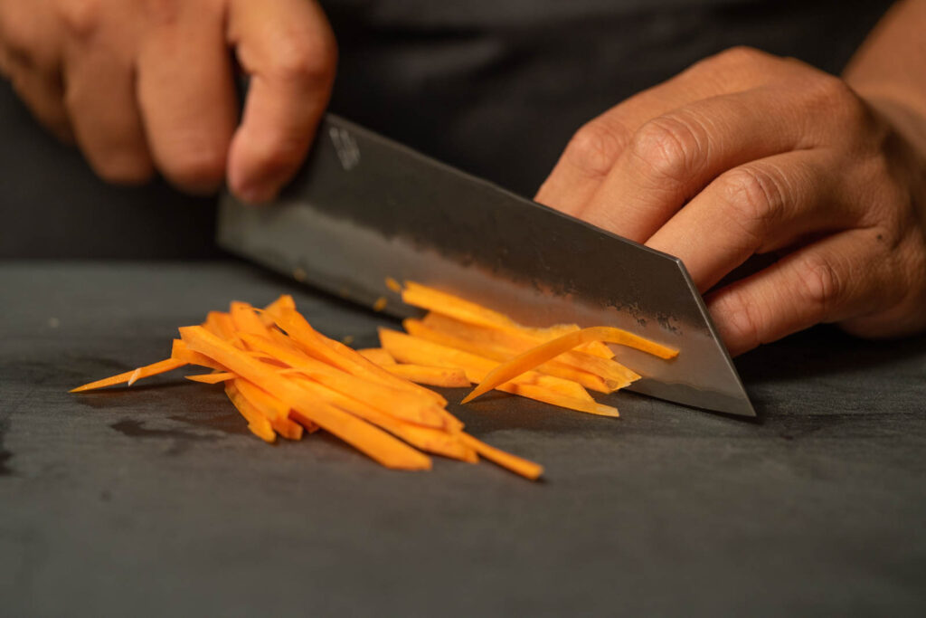 Thinly slice carrots