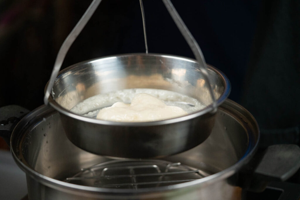 Removing mochi bowl from steamer