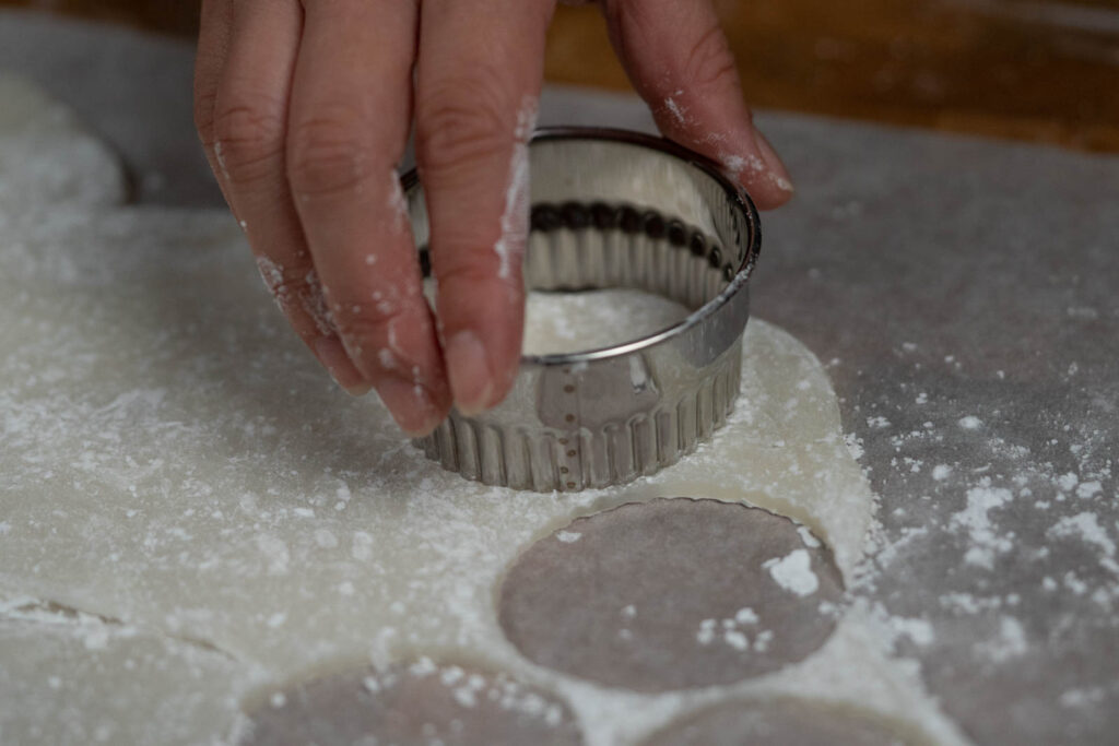 using a cookie cutter to cut mochi