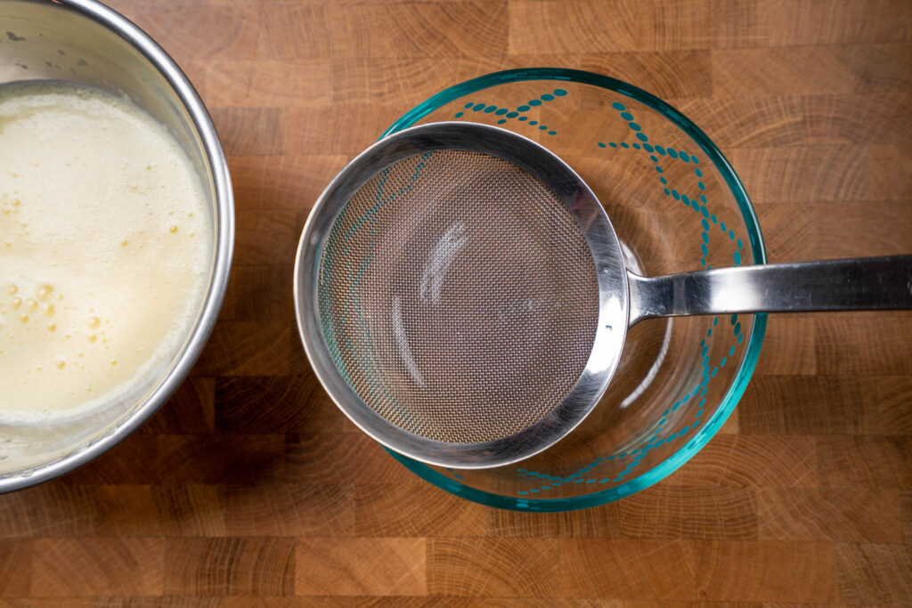 Strain egg pudding mix into container