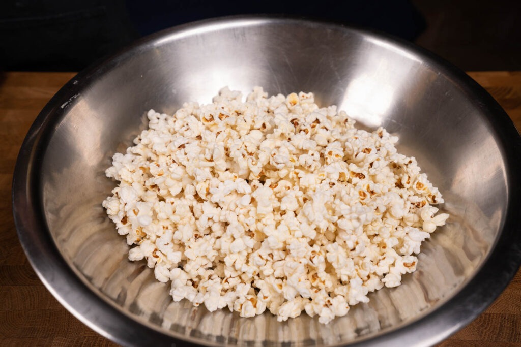 Make popcorn: Place popcorn in large bowl